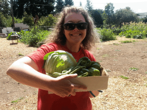 BEST Founder, Penny Condoll, enjoys the garden bounty at Victory Farms! 